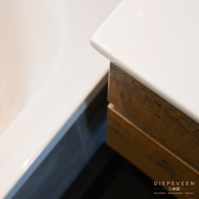 Het hout in combinatie met grijs en wit geeft een verfrissende tint aan de badkamer